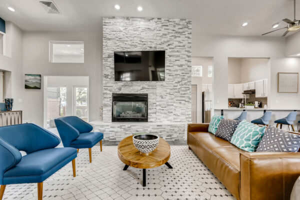 Copper Ridge apartment clubroom with plush seating, fireplace, and TV.