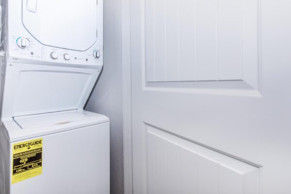 Cottages at Jet Wing apartment laundry closet with stacked washer dryer.
