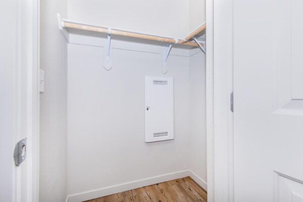 Cottages at Jet Wing apartment closet with built in shelves and clothing hangers.