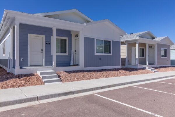 Cottages at Turin Point apartments with rocky landscaping and colorful buildings.