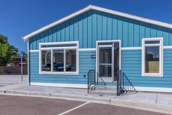 Cottages at Turin Point apartments with ample parking and colorful buildings.