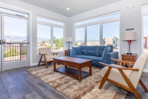 Cottages at Turin Point apartments common area with plush seating and large windows.