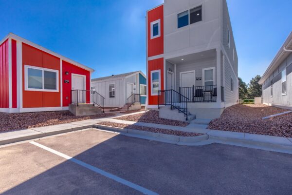 Cottages at Turin Point apartments with rocky landscaping and colorful buildings.