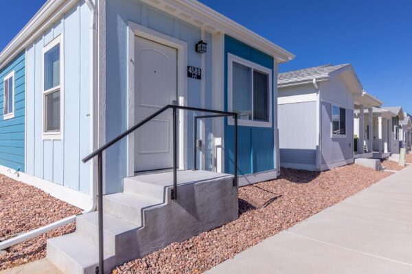 Cottages at Turin Point apartments with rocky landscaping and colorful buildings.