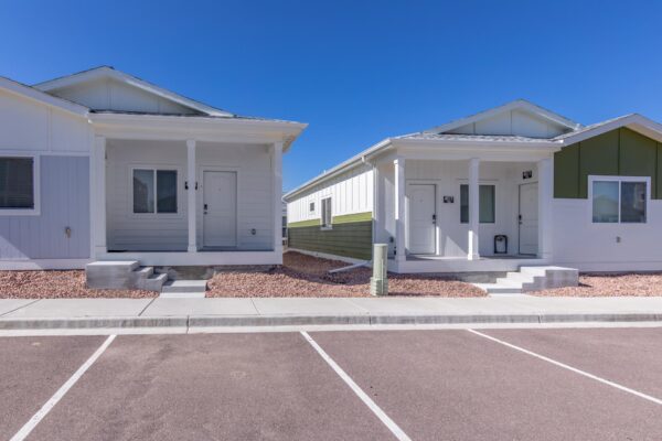 Cottages at Turin Point apartments with rocky landscaping and colorful buildings.