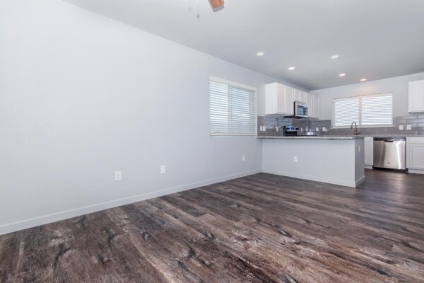 Cottages at Torin Point apartment living room with wood style floor and gray walls.
