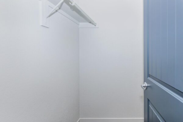 Cottages at Torin Point apartment closet with built in shelf and hanging rod.