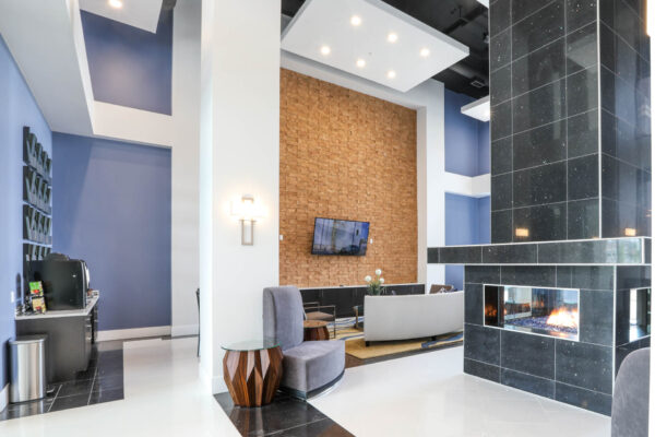 Forum Fitzsimons apartments lobby with plush seating and fireplace.