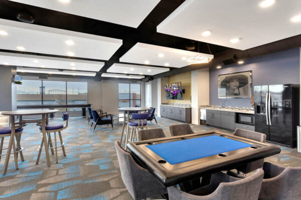 Forum Fitzsimons apartments clubroom with poker table and community kitchen.