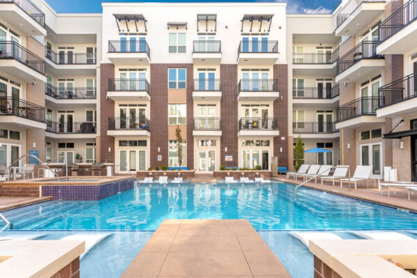 Forum Fitzsimons apartments pool area with lounge chairs and hot tub.