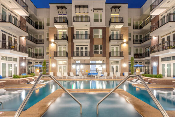 Forum Fitzsimons apartments pool area with lounge chairs and hot tub.