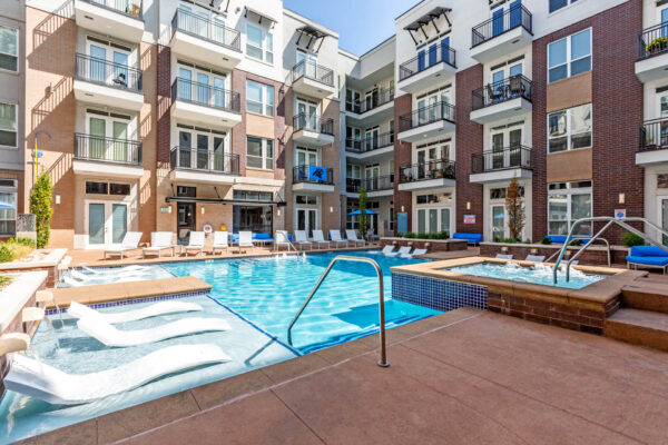 Forum Fitzsimons apartments pool area with lounge chairs and hot tub.