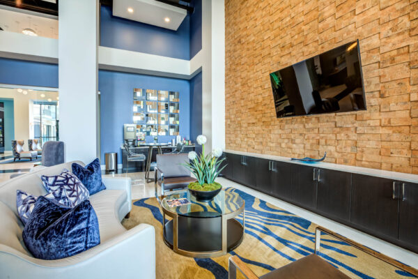 Forum Fitzsimons apartments lounge with plush seating and TV.
