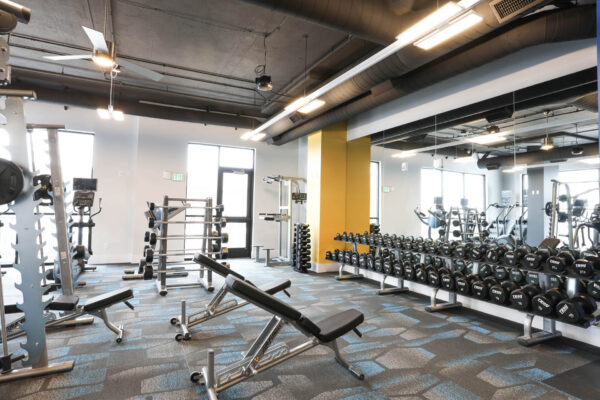 Forum Fitzsimons apartments fitness center with cardio machines and weight equipment.