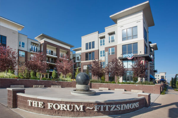 Forum Fitzsimons apartments courtyard with lush trees.