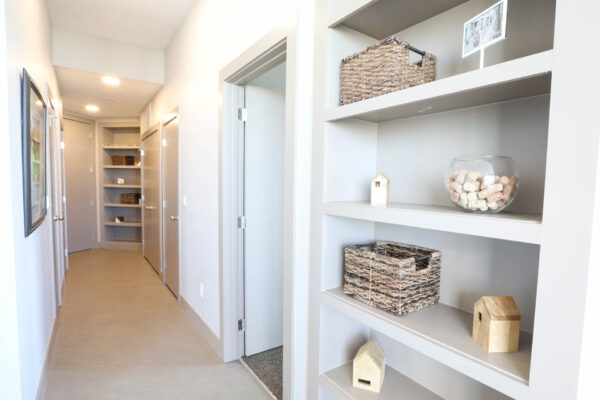 Forum Fitzsimons apartment hallway with built in shelves and decor.