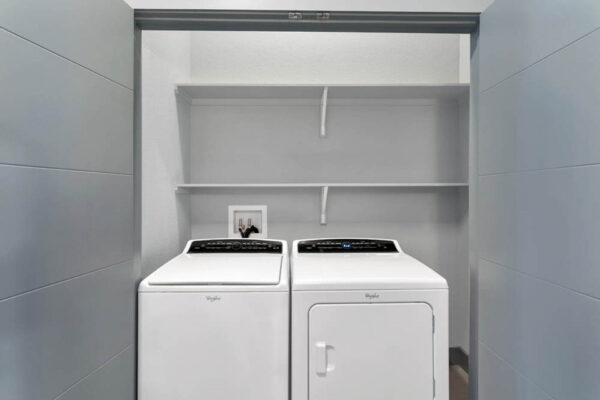 Forum Fitzsimons apartment laundry room with washer and dryer.