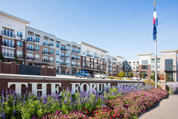 Forum Fitzsimons apartments with modern construction, ample parking, and retail spaces.