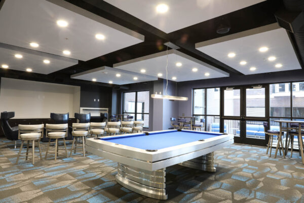 Forum Fitzsimons apartment clubroom with ample seating and pool table.