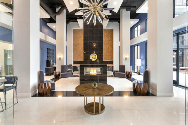 Forum Fitzsimons apartment lobby with seating, eclectic decor, and fireplace.