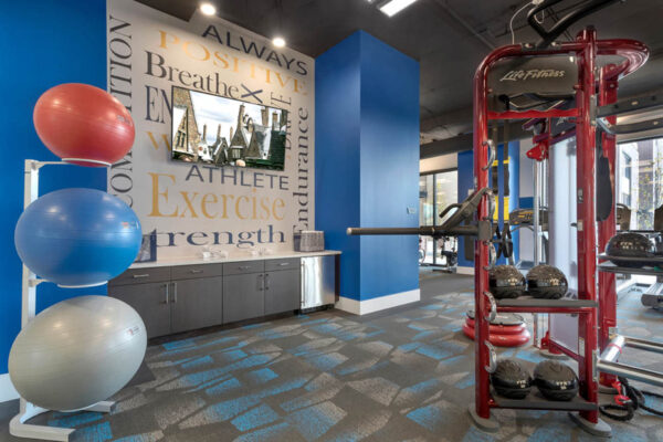 Forum Fitzsimons apartments fitness center with weight equipment and balance balls.