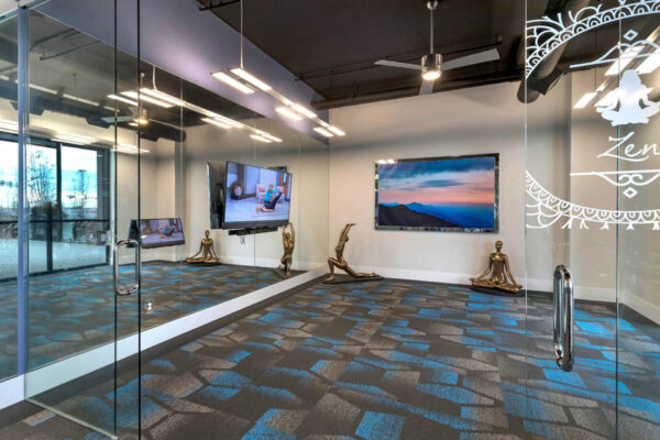 Forum Fitzsimons apartments fitness center with yoga room.
