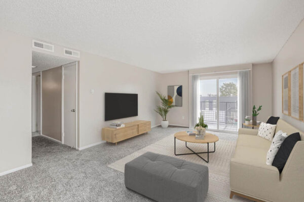 Heights on Huron apartments living room with plush carpet, hallway, plush modern seating and large windows.
