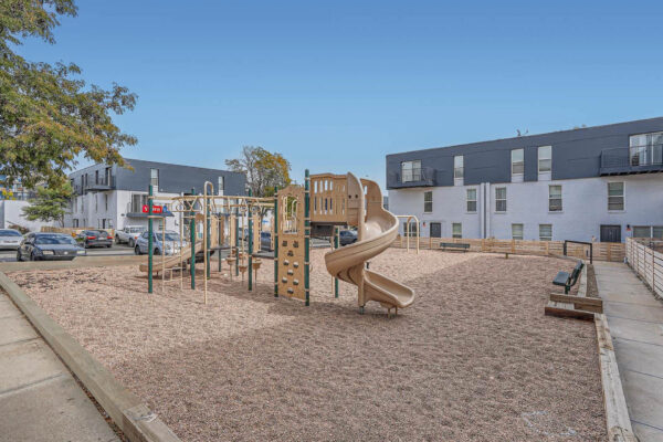 Heights on Huron apartments playground with pea gravel surfacing.