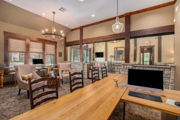 Highlands Lodge apartments leasing office with pattern carpets, plush chairs, and large desks.
