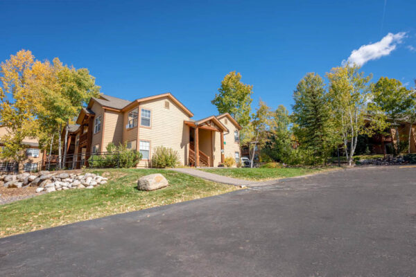 Mountain Village apartments buildings with walkway, wooden stairway and driveway.