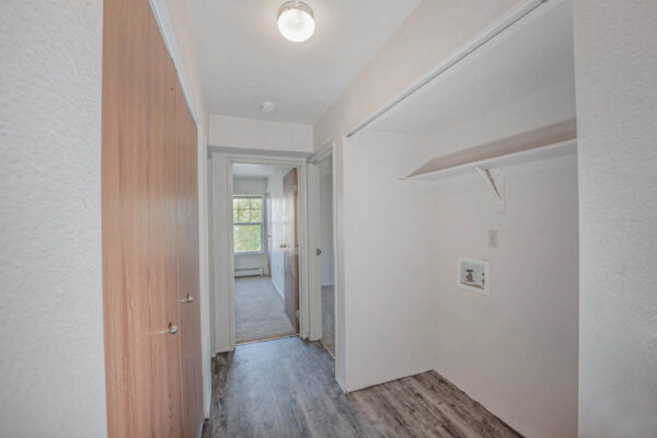 Mountain Village apartments hallway with wooden floors, wood doors and built in shelves.