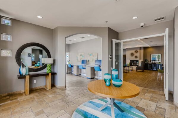 Pavilions at Arrowhead apartments clubhouse with business center and lobby with colorful decor.