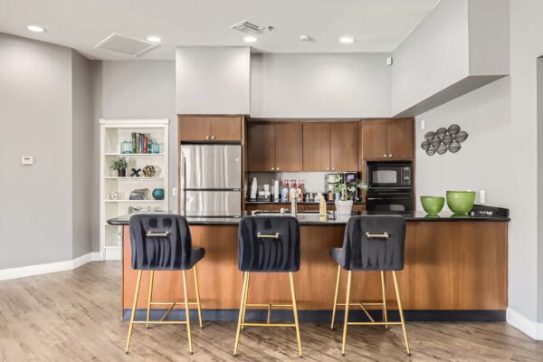 Pavilions at Arrowhead apartments community kitchen with breakfast bar.