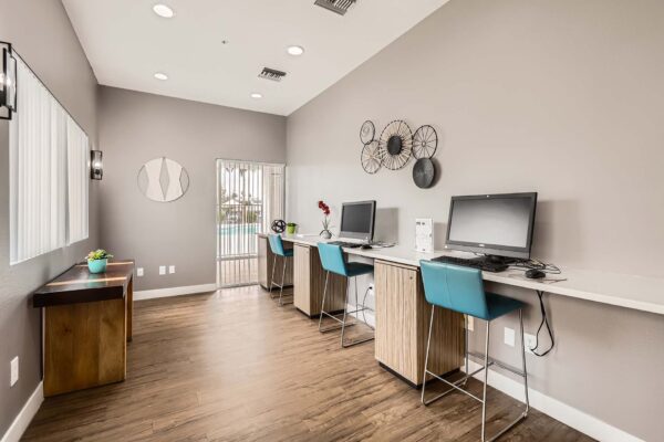 Pavilions at Arrowhead apartments business center with computer desks.