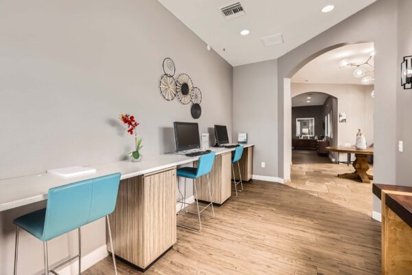 Pavilions at Arrowhead apartments business center with computer desks.