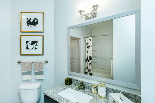 Residence at Old Hickory Lake apartments bathroom with large mirror and quartz countertop.