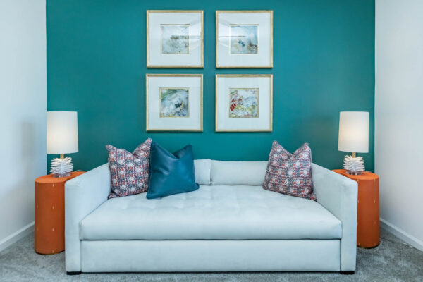 Residence at Old Hickory Lake apartments green painted walls, abstract artwork, and comfortable seating on plush carpet.