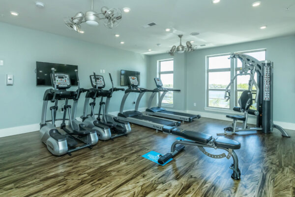 Residence at Old Hickory Lake apartments fitness center equipped with cardio machines, light fixtures and wood flooring.