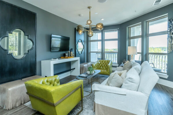 Residence at Old Hickory Lake apartments spacious lounge area with comfortable seating, large windows, light fixtures and decorations displayed nearby.