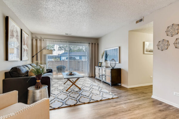 Sky at Bear Creek apartments living room with wood-style flooring and door to patio/balcony
