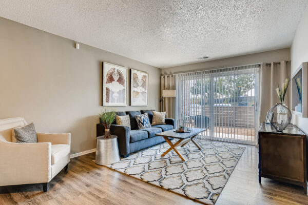 Sky at Bear Creek apartments living room with wood-style flooring and door to patio/balcony