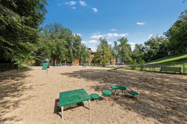 Sky at Bear Creek apartments bark park with bench and agility equipment
