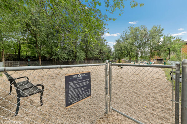 Sky at Bear Creek apartments bark park with bench and agility equipment