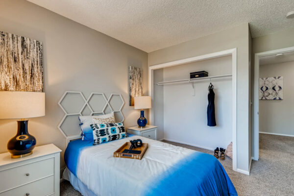Sunset Peak apartments bedroom interior featuring gray walls and an open closet