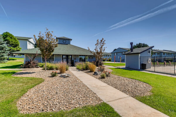 Sunset Peak apartments entrance of the leasing office with well landscaped grounds and trees
