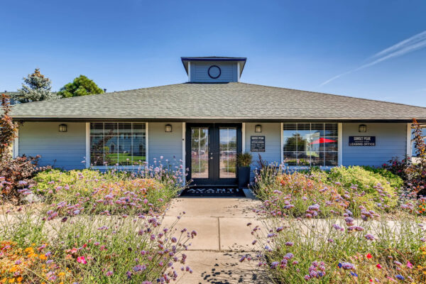 Sunset Peak apartments entrance of the leasing office with floral shrubs