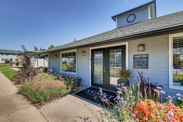 Sunset Peak apartments entrance of the leasing office with well landscaped floral shrubs