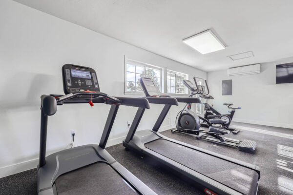 Sunset Peak apartments indoor fitness center featuring two treadmills