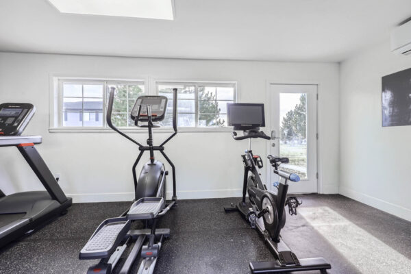 Sunset Peak apartments indoor fitness center featuring an elliptical, and a spin bike