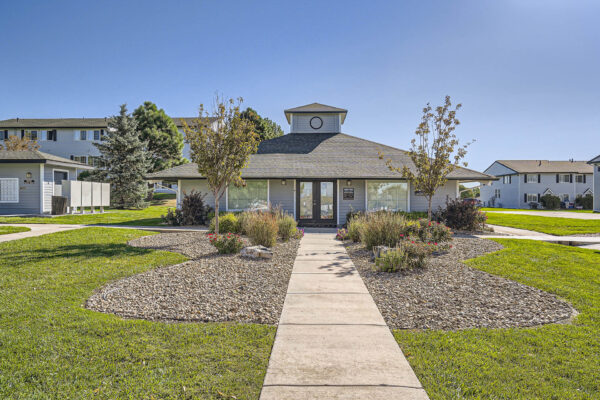 Sunset Peak apartments entrance of the leasing office with well landscaped grounds and trees